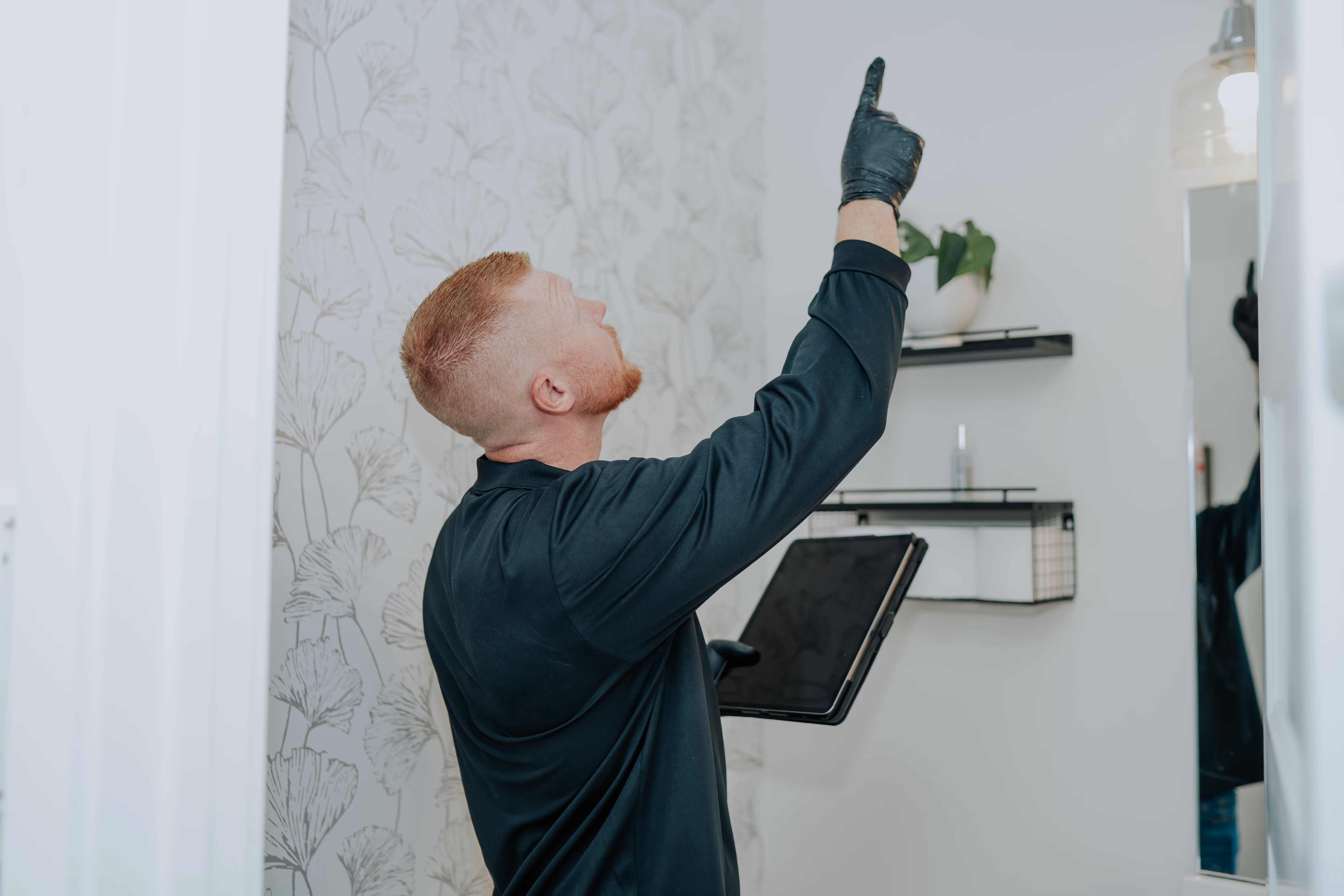 A Lone Star Pure Maintenance specialist checking a ceiling during a home inspection